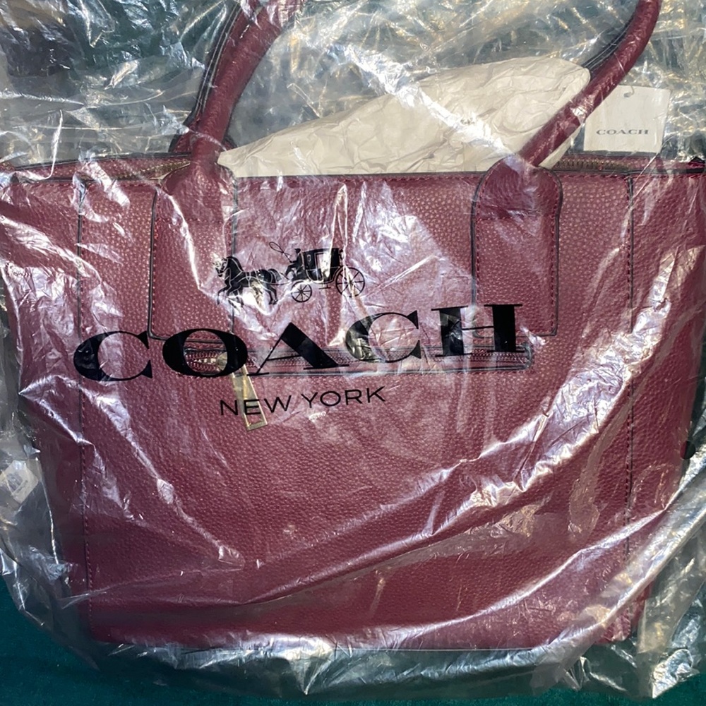 Brand new Coach purse still in  plastic